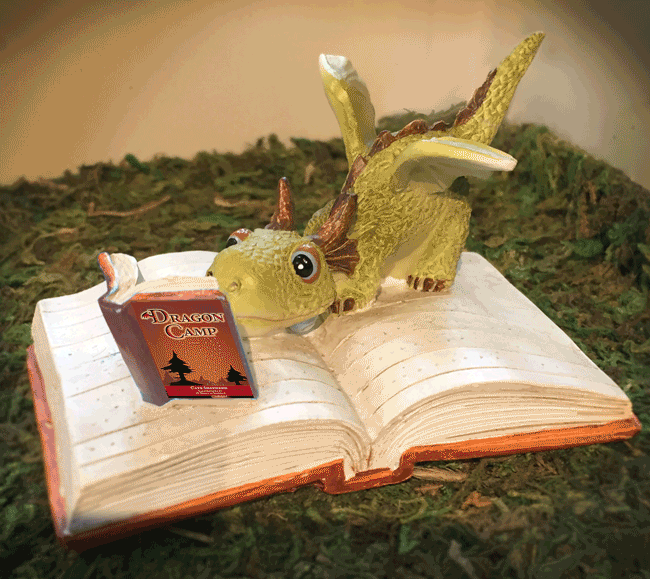 Animated gif of dragon figurine in which the little dragon is reading a copy of Dragon Camp